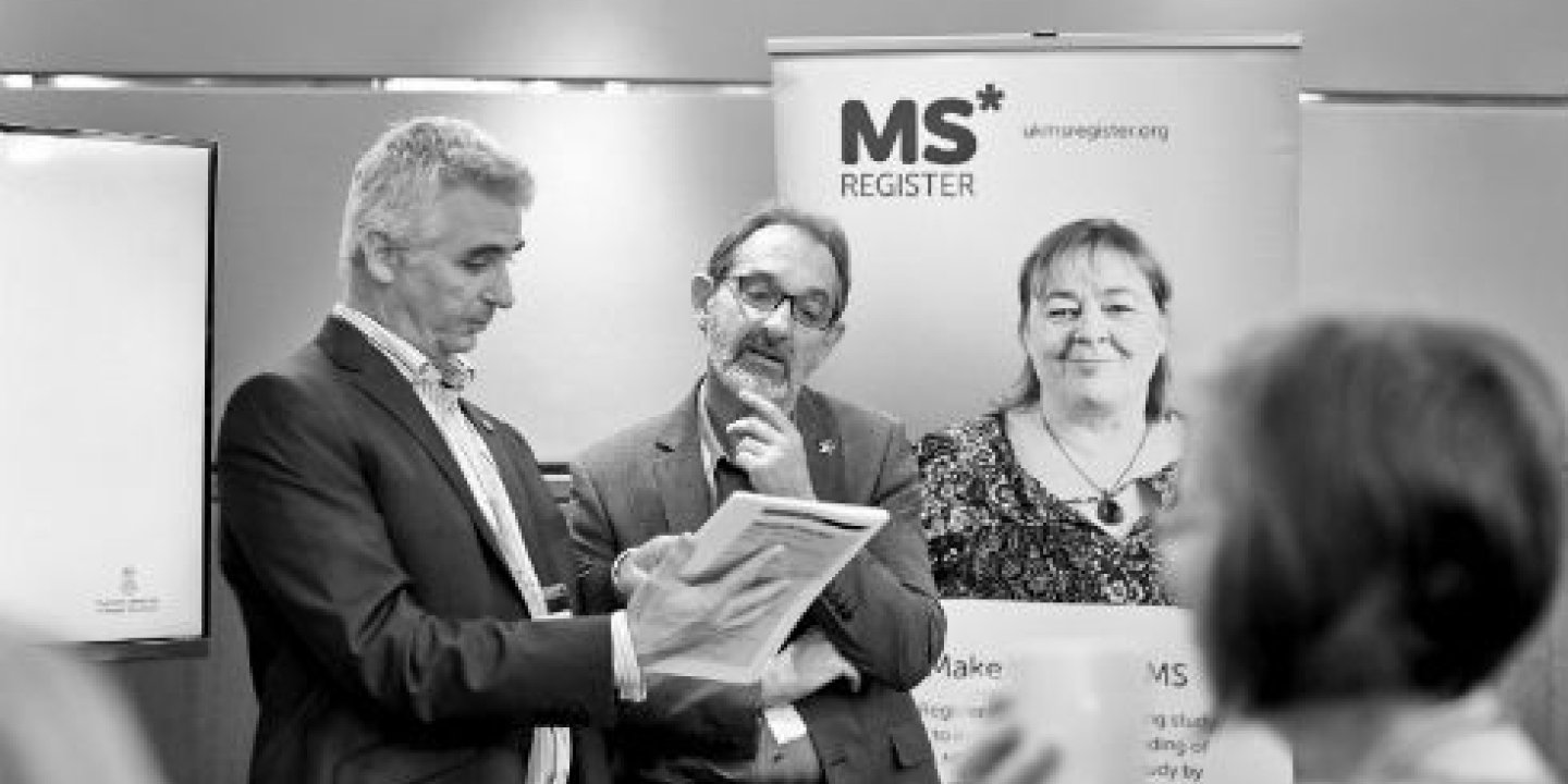 Photograph of two people at the MS Register's stand at a conference