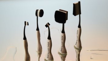 A series of makeup brushes with specially designed handles.