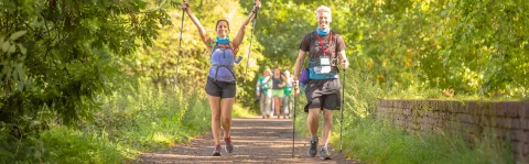 Two people walk the Thames Path Challenge