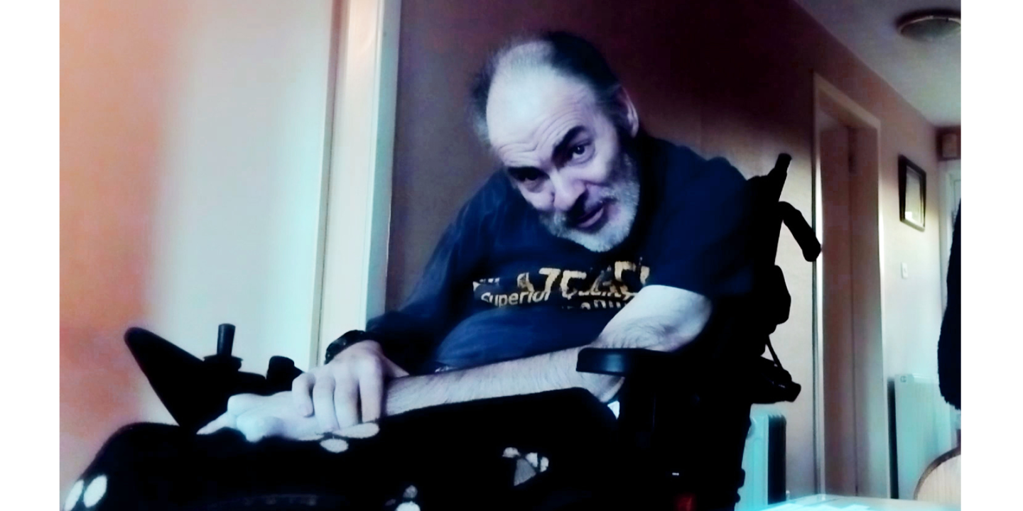 A Man in a motorised chair looking to camera