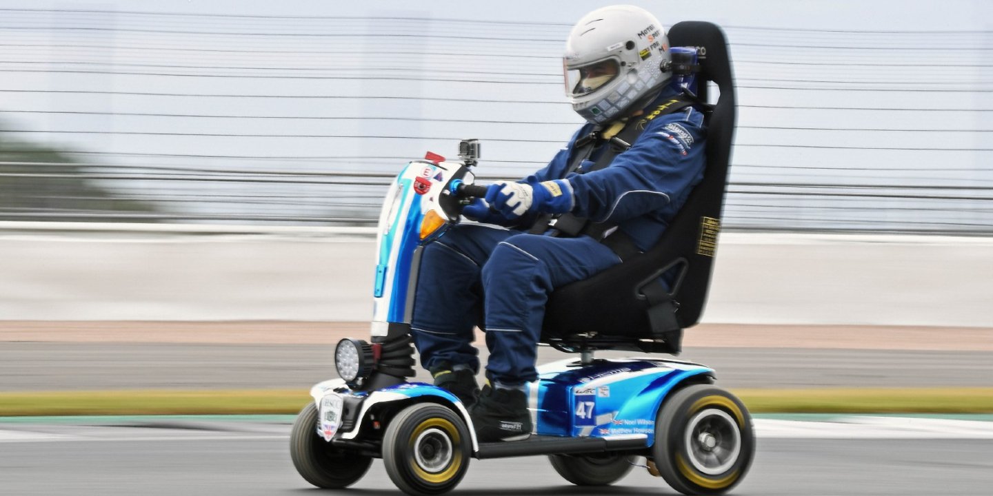 Noel racing his scooter, with blurred background