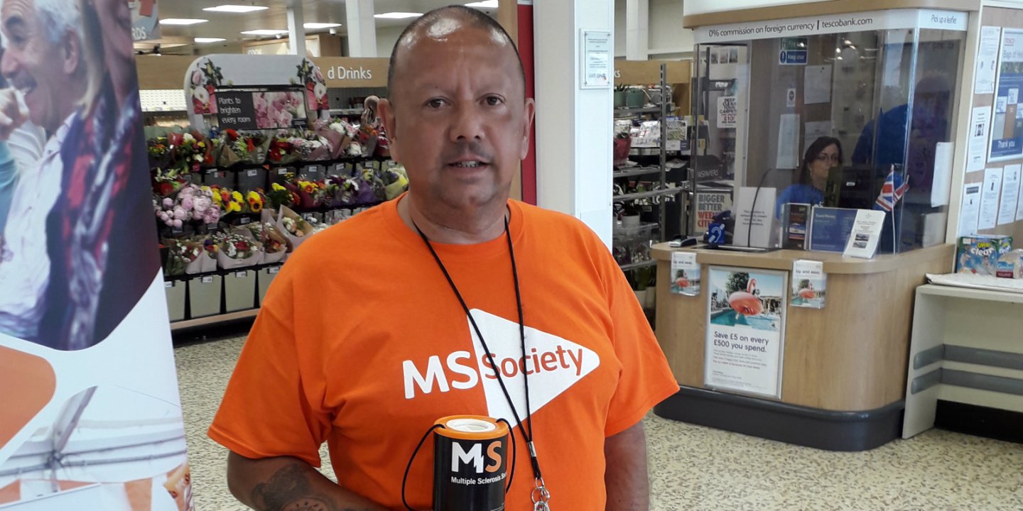 Roy Porter fundraising in a supermarket wearing an MS Society t-shirt