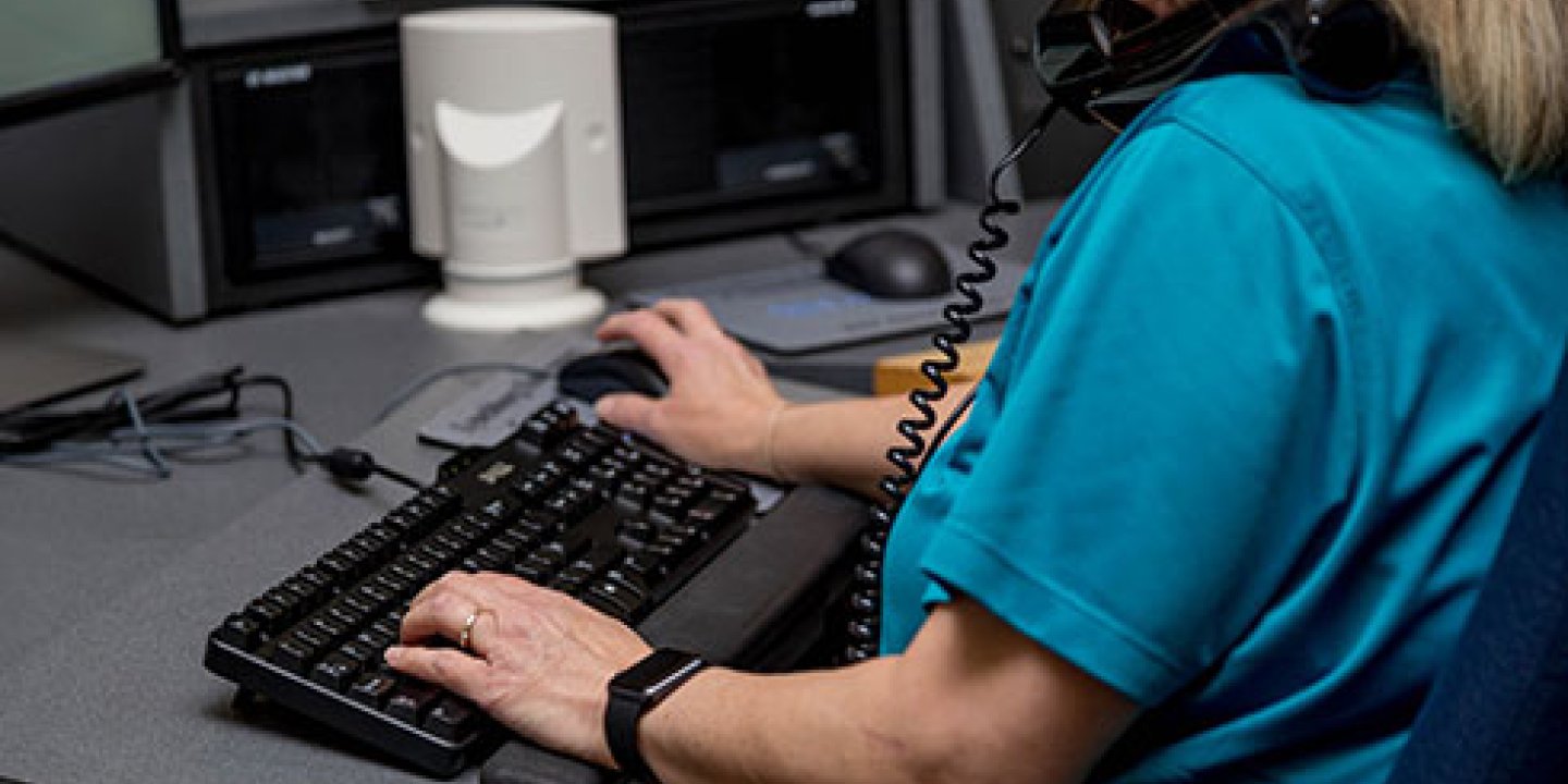 Image shows an MS nurse using a computer