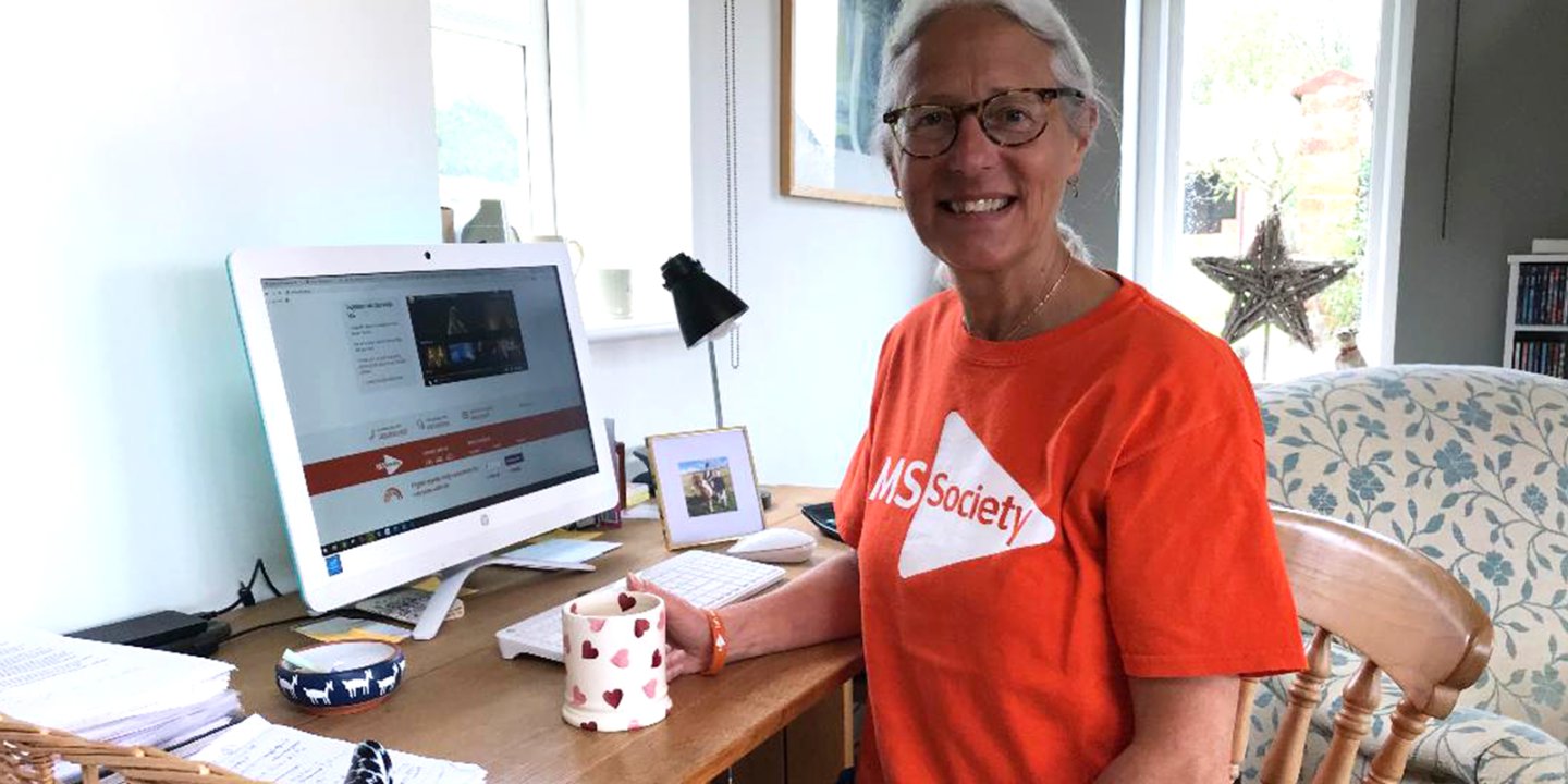 Jacqueline sits at her computer at home