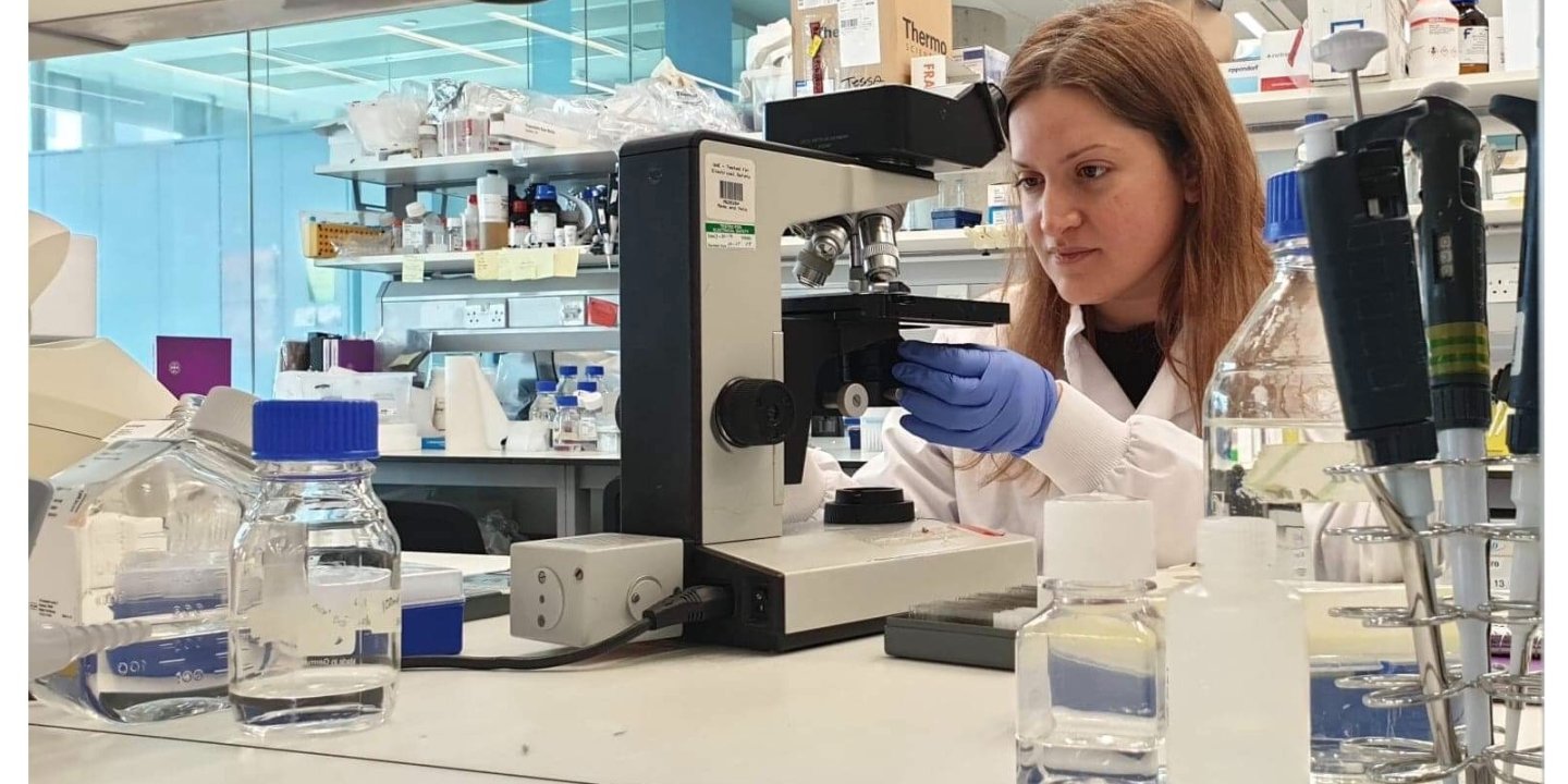 Photo of Dr Lida Zoupi using a microscope