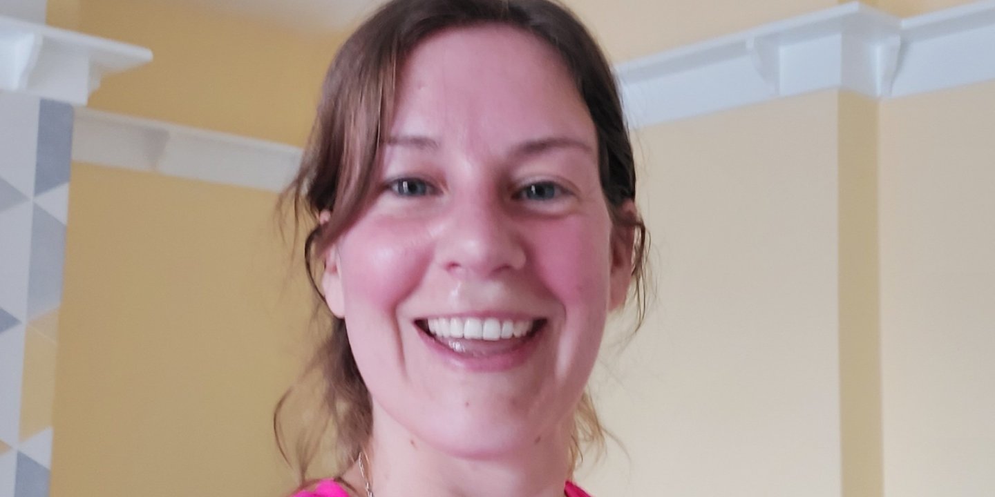 Headshot of Em after a workout looking happy