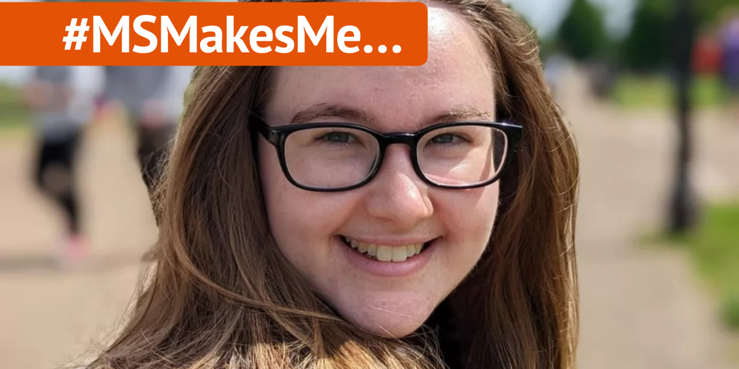 Jenni is smiling to the camera she is white with long brown hair and wears glasses. A banner with #MSMakesMe runs above her photo