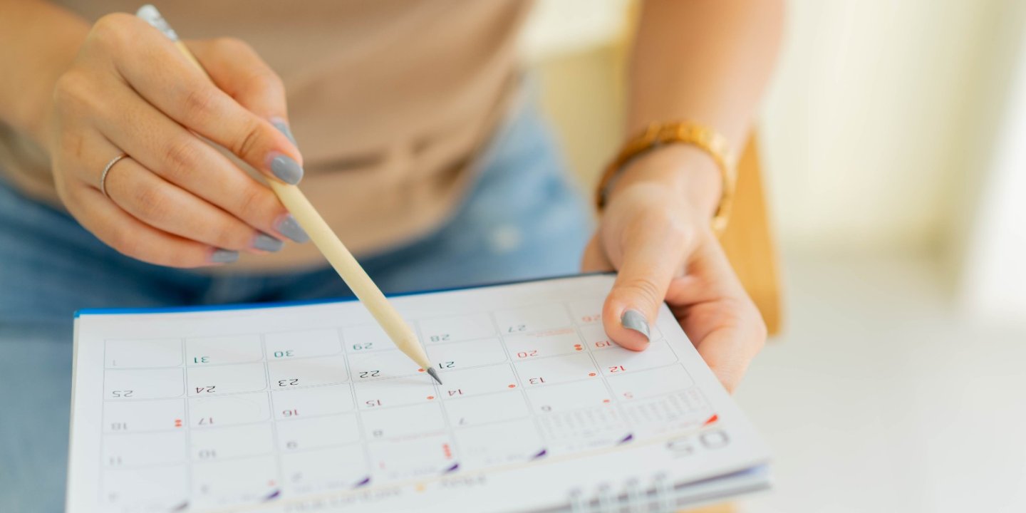 Women writes on a calendar. 