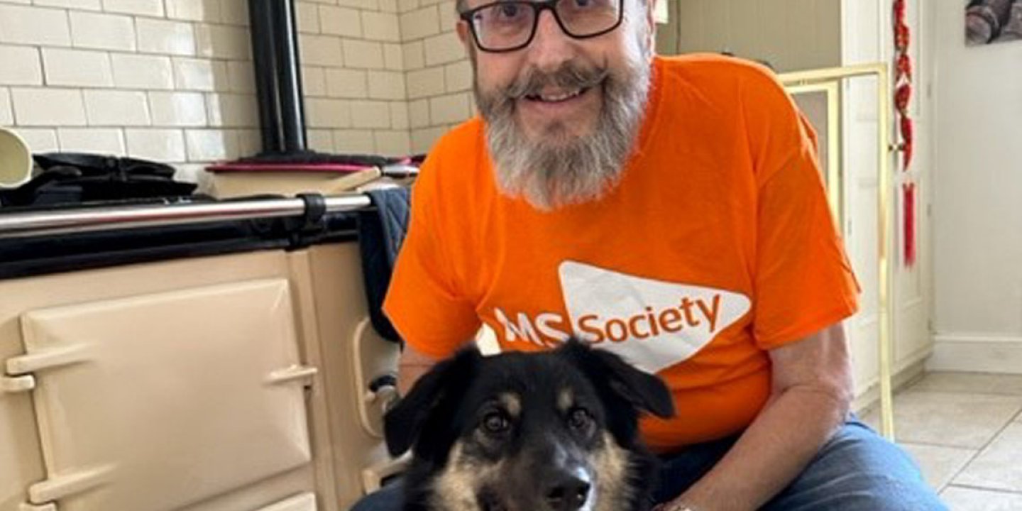 Dave Myers in an MS Society t shirt with his dog Teddy