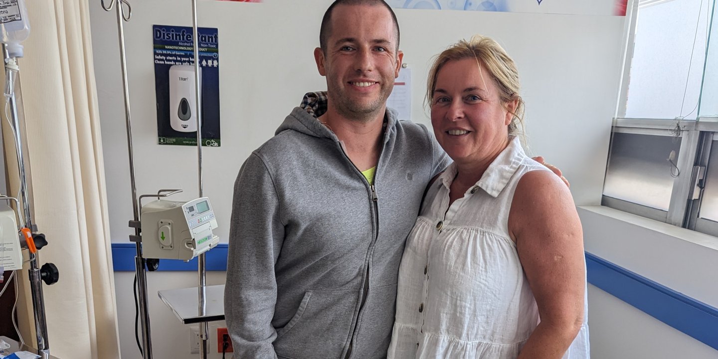 A man and woman in a hospital smiling at the camera