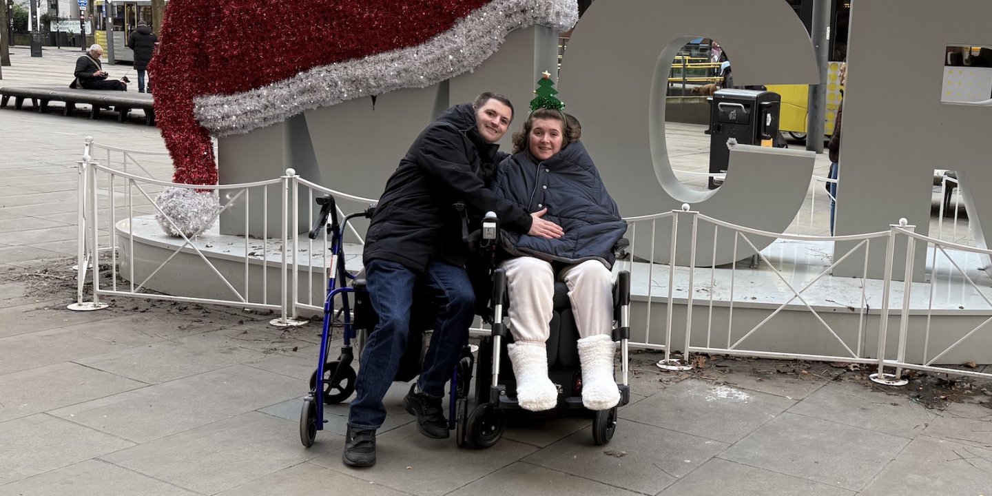 Jasmine and her boyfriend outside in a town centre