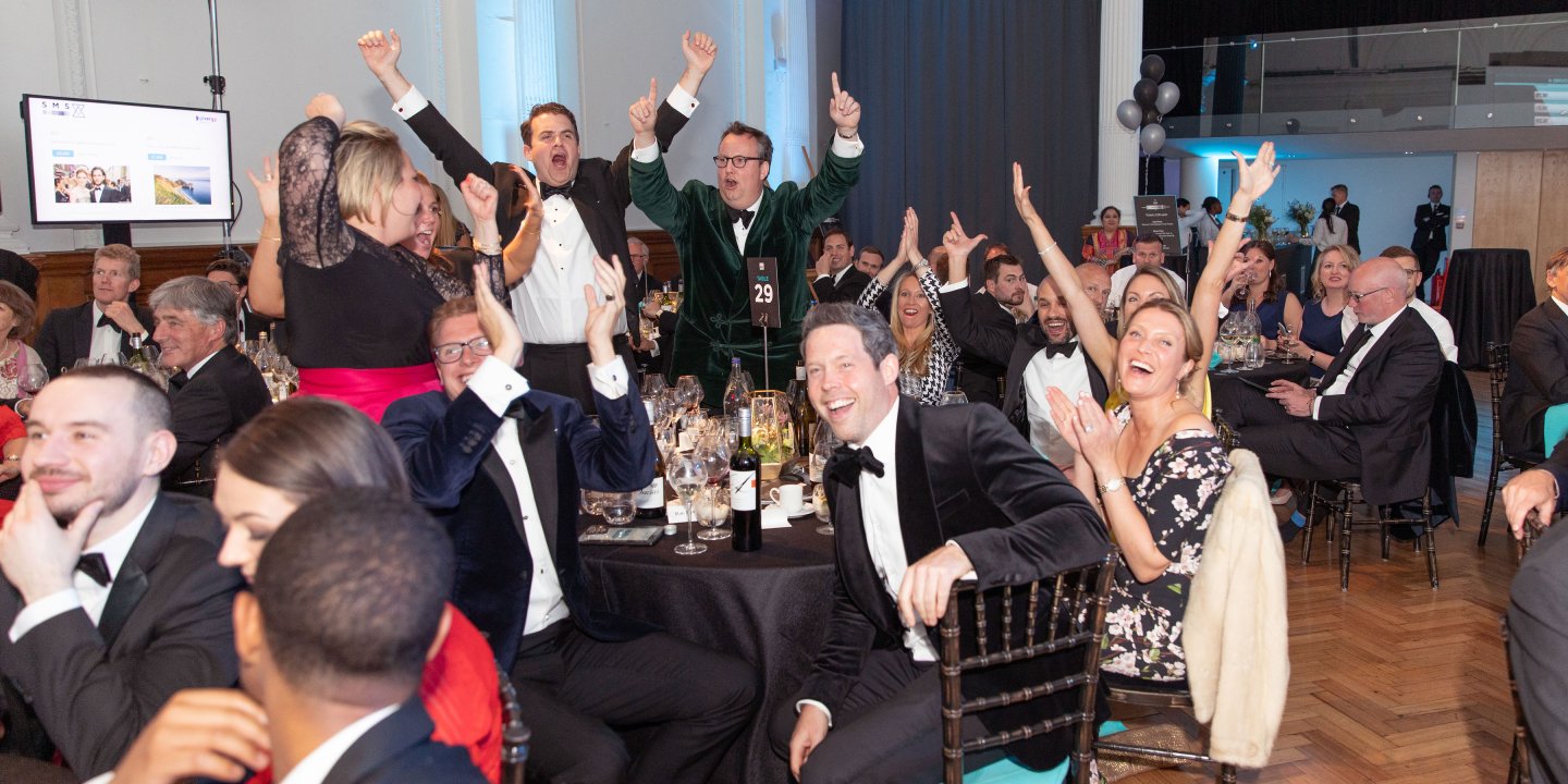 Photo of a large group of people at a formal event