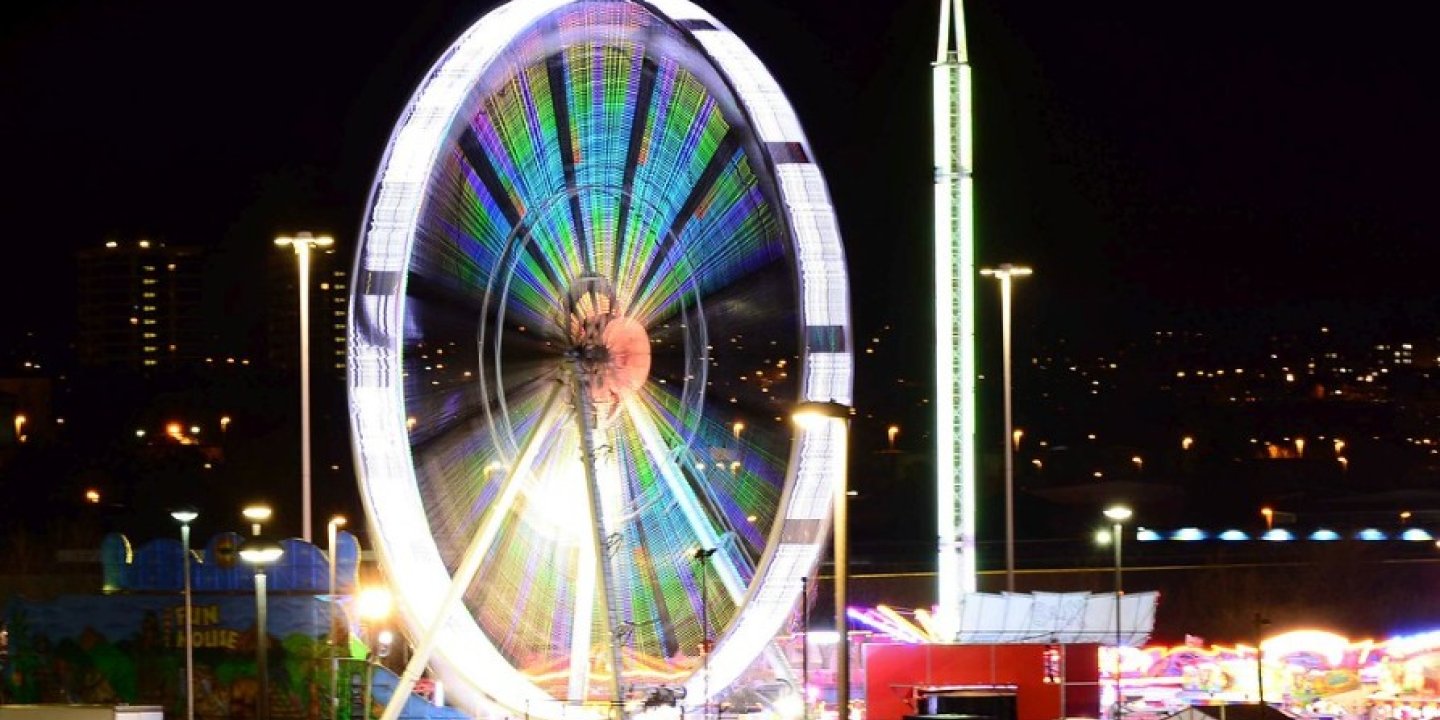 An image of a big wheel lit up at night.