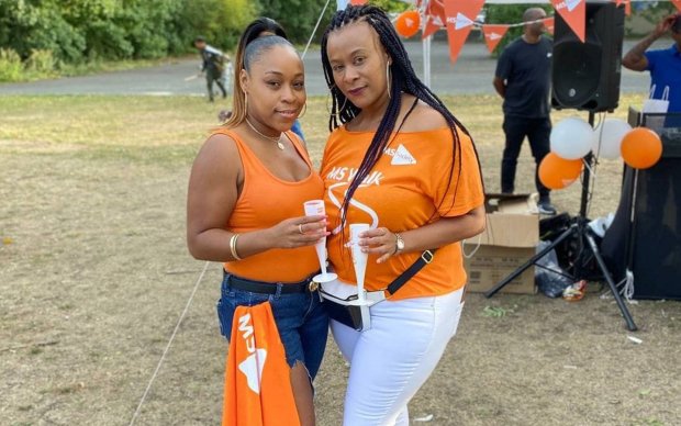 Two fundraisers wearing My MS Walk t-shirts holding drinks