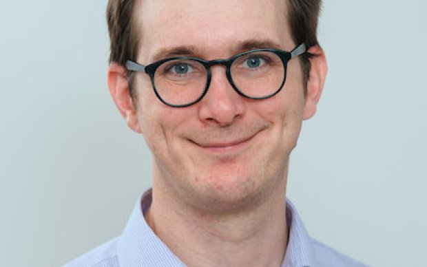 Dr David Hunt, a man with short brown hair and dark rimmed glasses wearing a blue shirt
