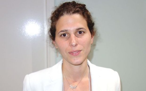 Dr Yael Hacohen, a woman in a white blazer with dark hair and brown eyes