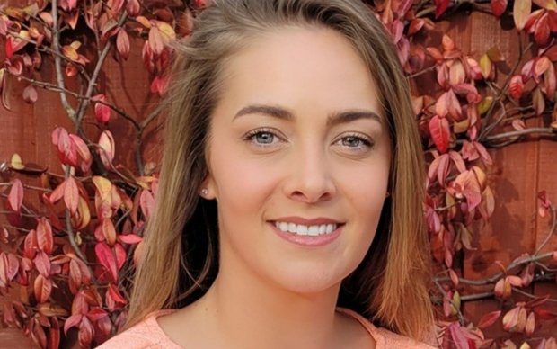 The photo shows Jade smiling at the camera against a flowery background.