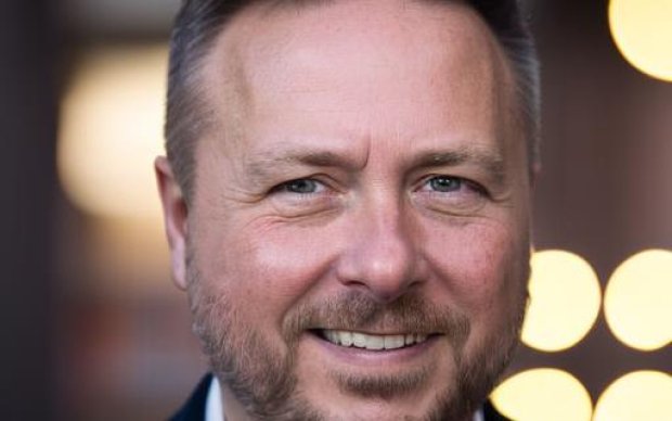 Headshot of Matthew Ward, in front of dappled, out-of-focus light.