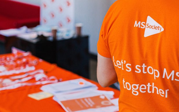 Table with pamphlets and a T-shirt