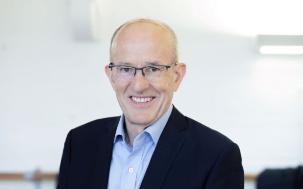 Headshot of Sir Paul Curran against a white background