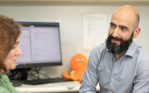 Image shows Dr Sean Apap Mangion with an Octopus trial participant. There is a small orange Octopus stuffed toy in the background.