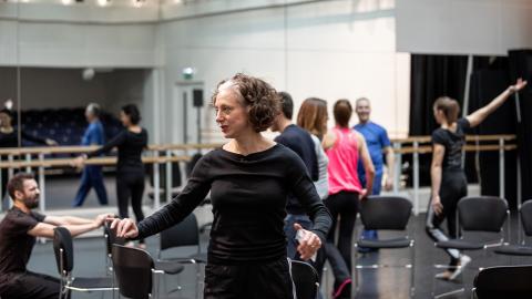 Choreographer Bim Malcomson leading ballet workshop in dance studio with people with MS