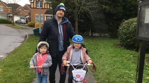 Dave and his two daughters on a walk.