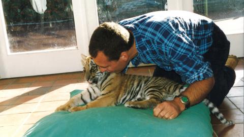 Dave kissing a tiger cub