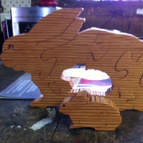Photo: wooden jigsaw in the shape of a bunny with a bunny shape piece missing