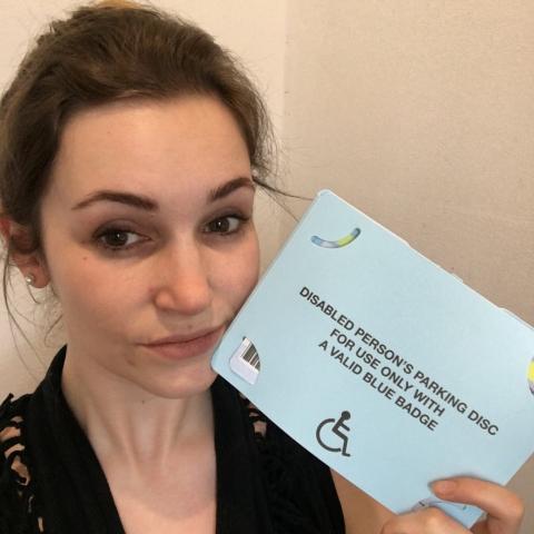 Jessie holding her blue badge