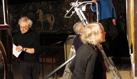 Lorne and Cathy working together in a gallery looking at an altarpiece