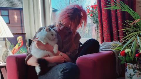 Rose and her cat Frankie in their flat