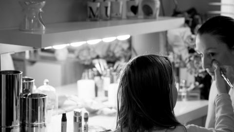 Black and white image of Kirsty having make up applied
