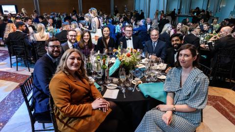 A table of guests smiles at the camera at SMS Battles. Photo copyright Brendan Foster