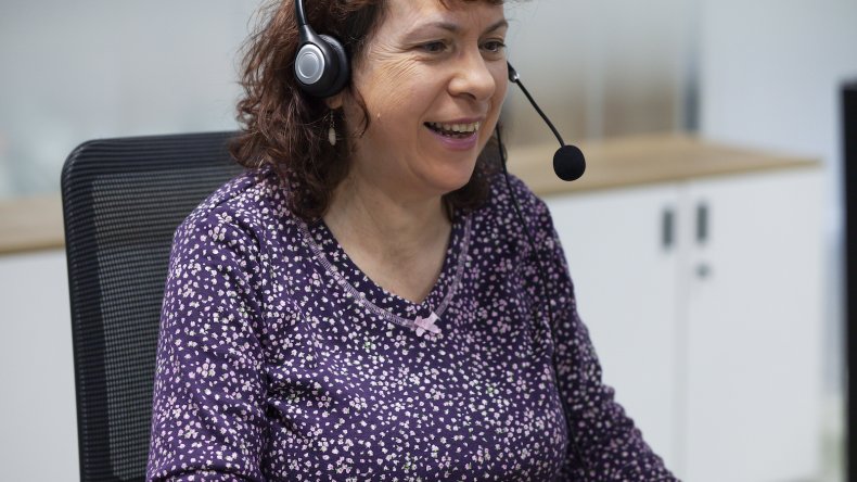A Helpline advisor wears a headset 