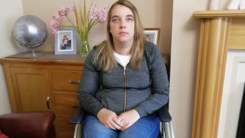 Susan at home using a wheelchair