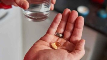 Close up of hand holding some pills