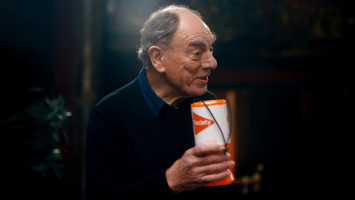 Actor Alun Armstrong holds an MS Society collecting can