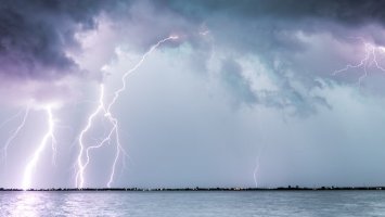 lightning striking over water