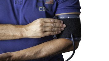 a man putting on a blood pressure monitor cuff