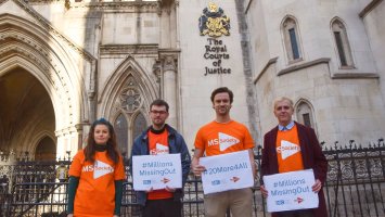 Staff in MS Society t-shirts with placards, outside the Royal Courts of Justice
