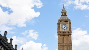 UK Parliament against a blue sky with clouds