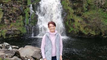 Photo of Siobhan O'Hanlon standing in front of a waterfall