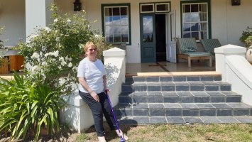 Barbara standing on a porch