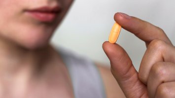 A person holding a pill 