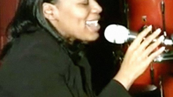 Jenique singing on stage