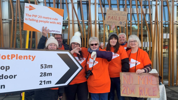 Six people wearing MS Society shirts campaign against the 20m benefits rule