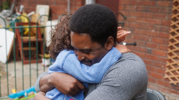 Close up of a man hugging his daughter