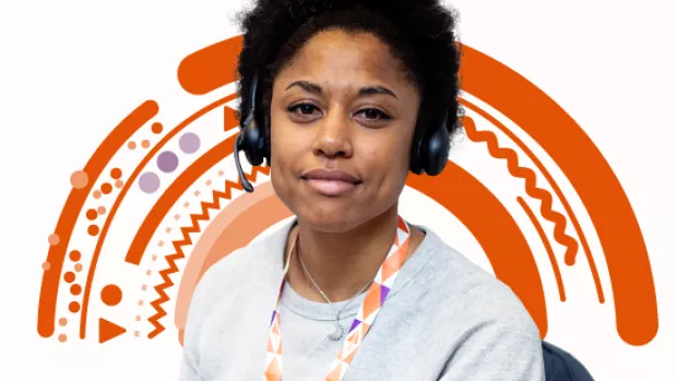 Photo shows smiling woman with headset in front of an orange rainbow