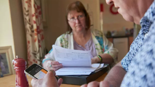 Photo: Couple calculating their finances at home